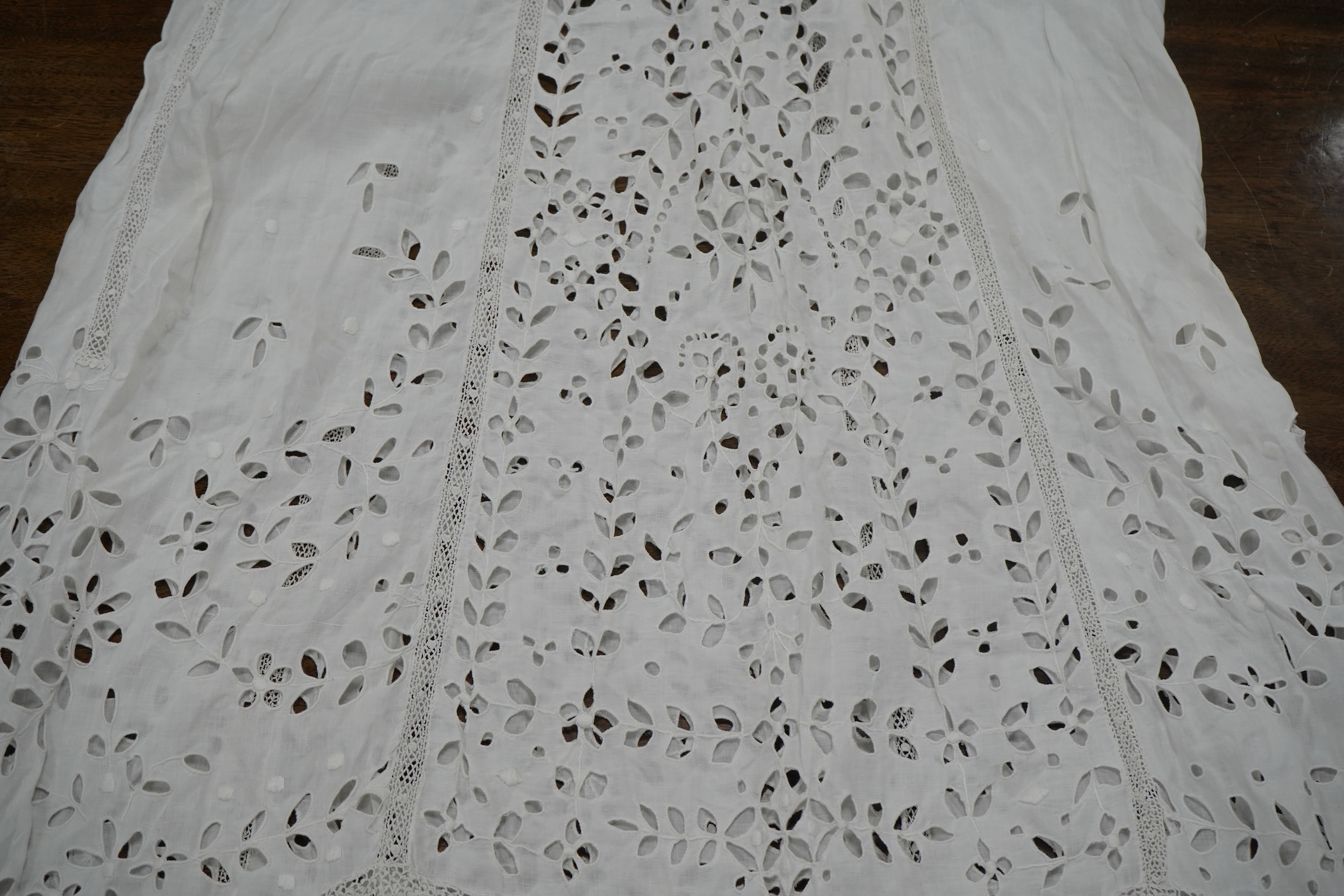 An Edwardian fine white embroidery anglaise and Irish crochet trimmed ladies summer dress, designed with large panels of anglaise cut work, the dress has been altered and restyled, which could be altered back, 134cm long